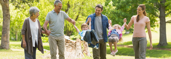 Chiropractic Duluth GA Couple with Child and Grandparents in Park